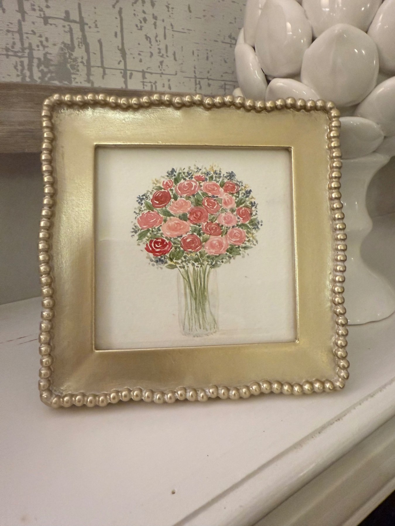 Pink floral bouquet in a gold frame