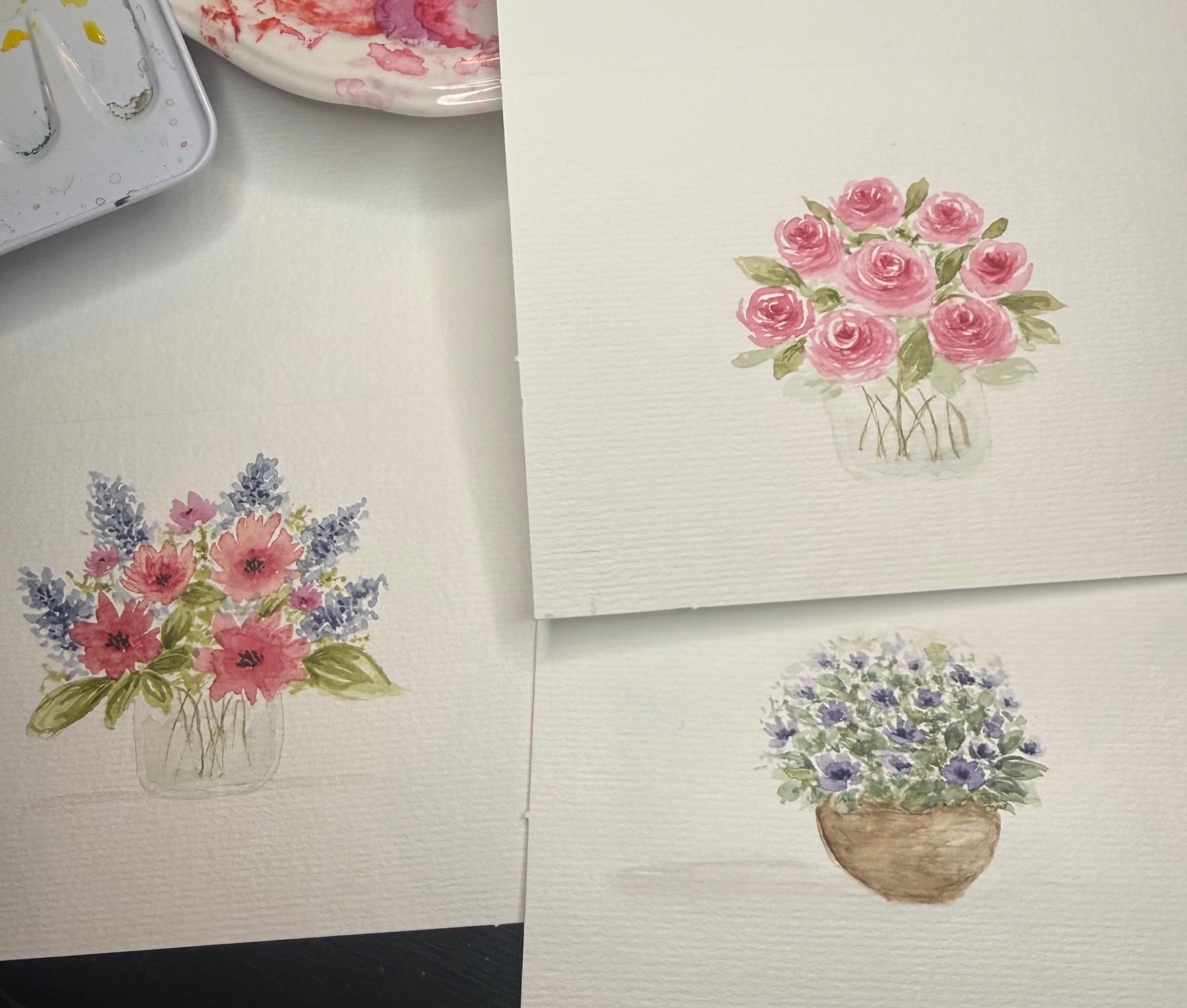 Pink roses and colorful bouquets painted on textured watercolor paper